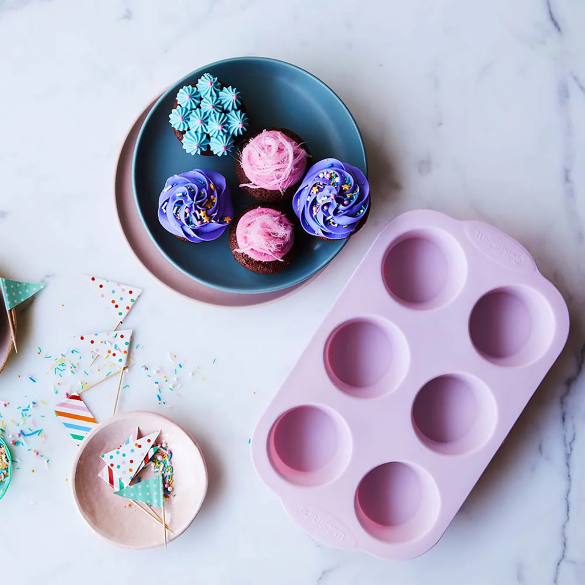 https://tomkin.com.au/cdn/shop/products/WLT40245_WILTSHIRE_PINK_MUFFIN_PAN_6_CUP_SILICONE_LIFESTYLE_LR_1200x.jpg?v=1677462961